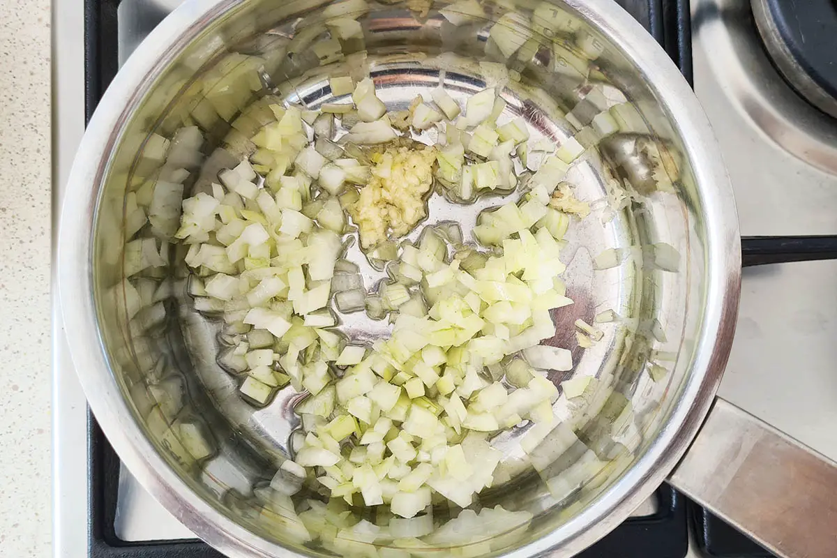 minced onion and garlic in a pan with olive oil