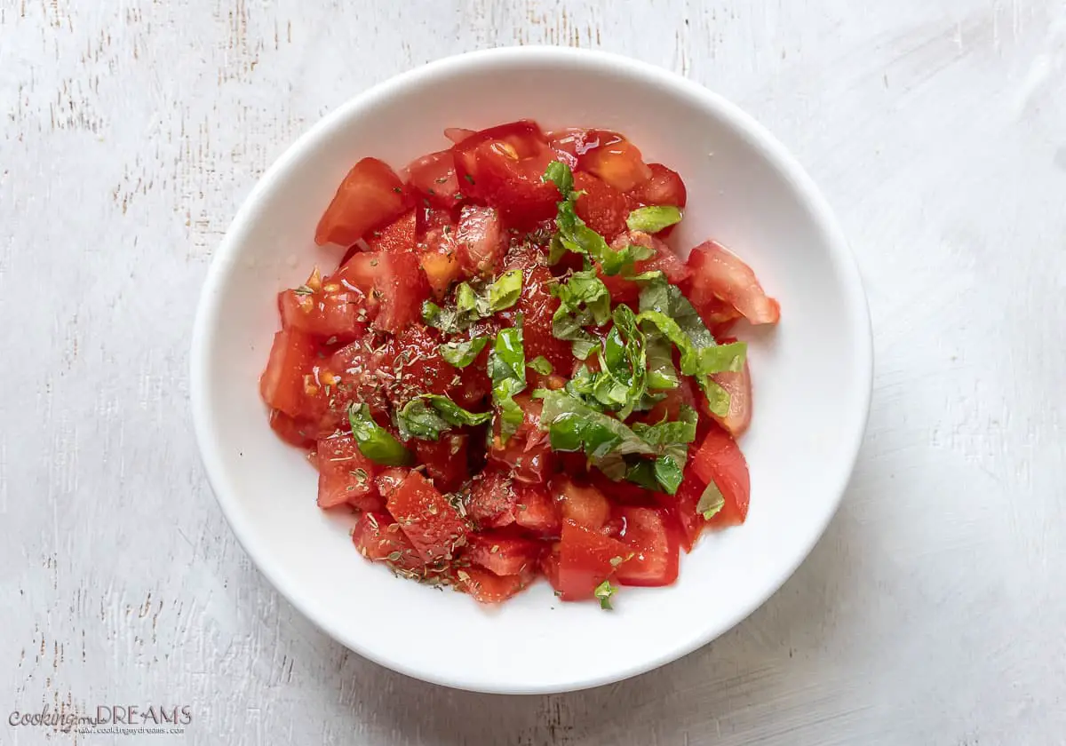 chopped tomatoes in a white bowl.