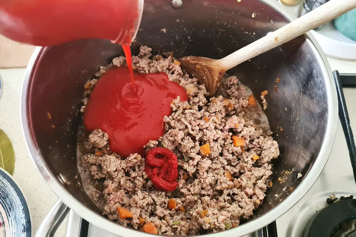 tomato passata is added to the meat.