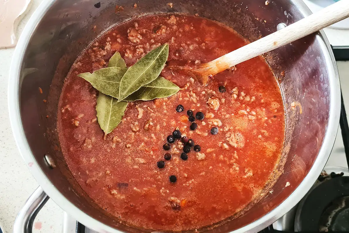 seasoning and spices are added to the ragù while it simmers.