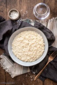 creamy garlic parmesan risotto on a plate next to a fork.