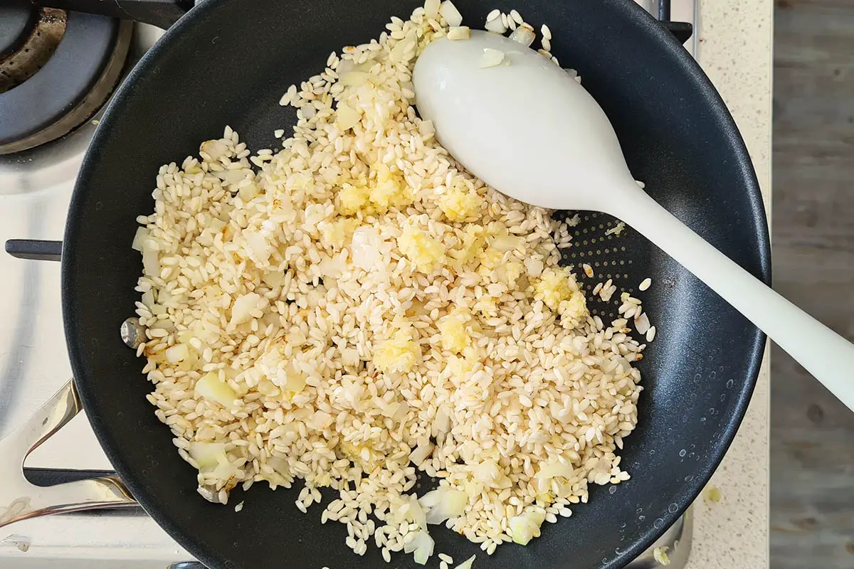 toast the rice with onion and garlic.