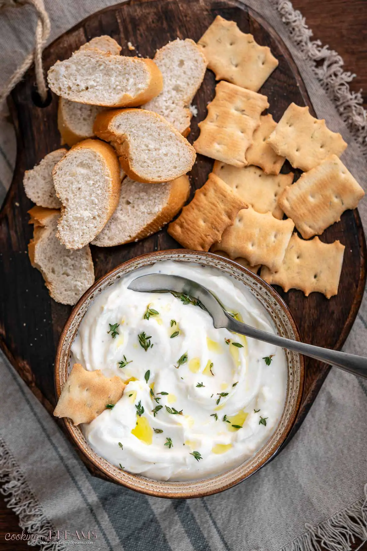 whipped ricotta dip in a bowl next to bread and crackers