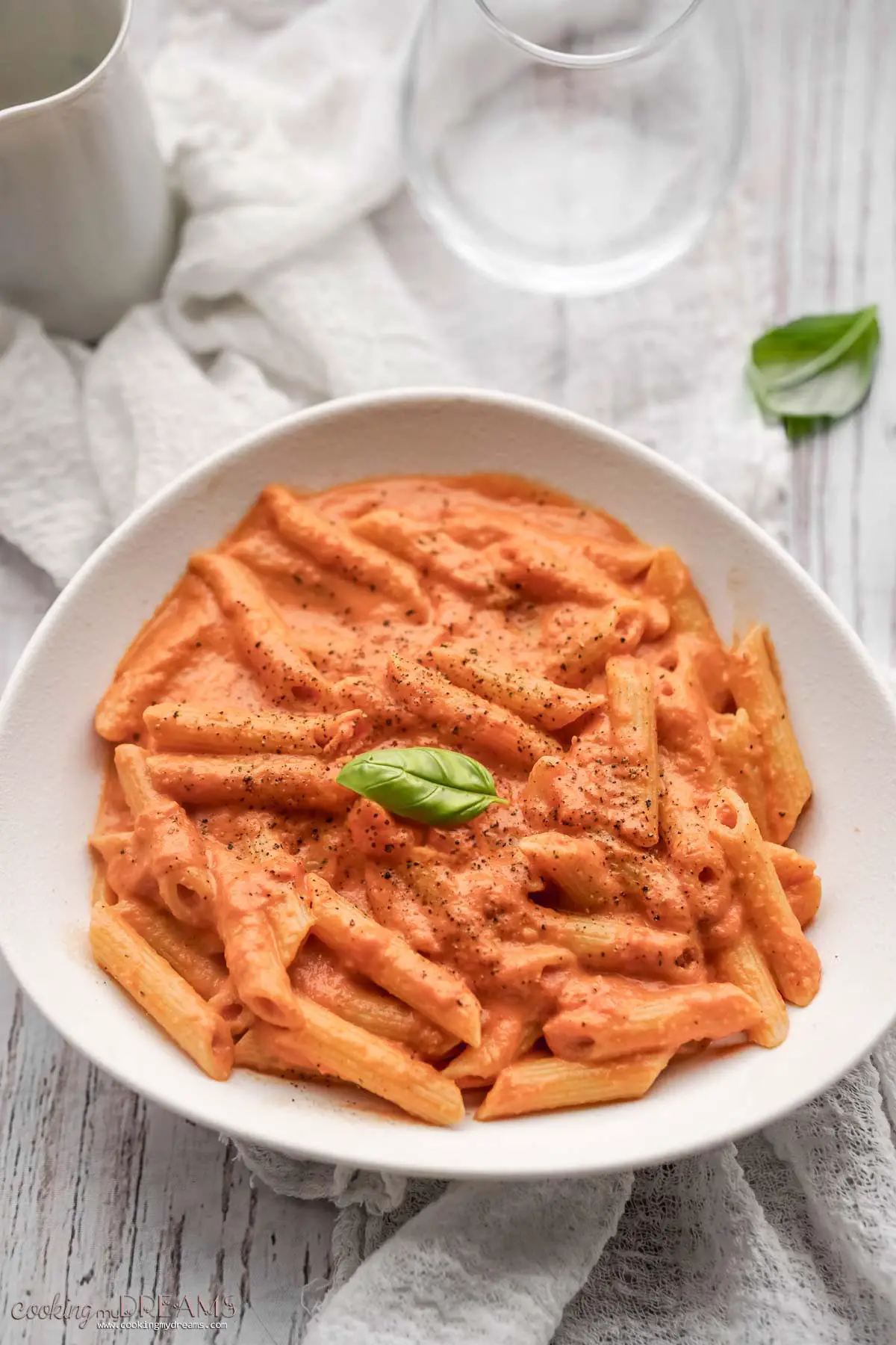 penne rosa in a white plate on the table.