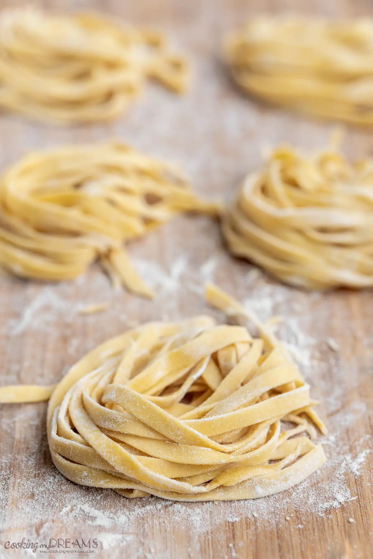 nest of fresh tagliatelle pasta on a cutting board.