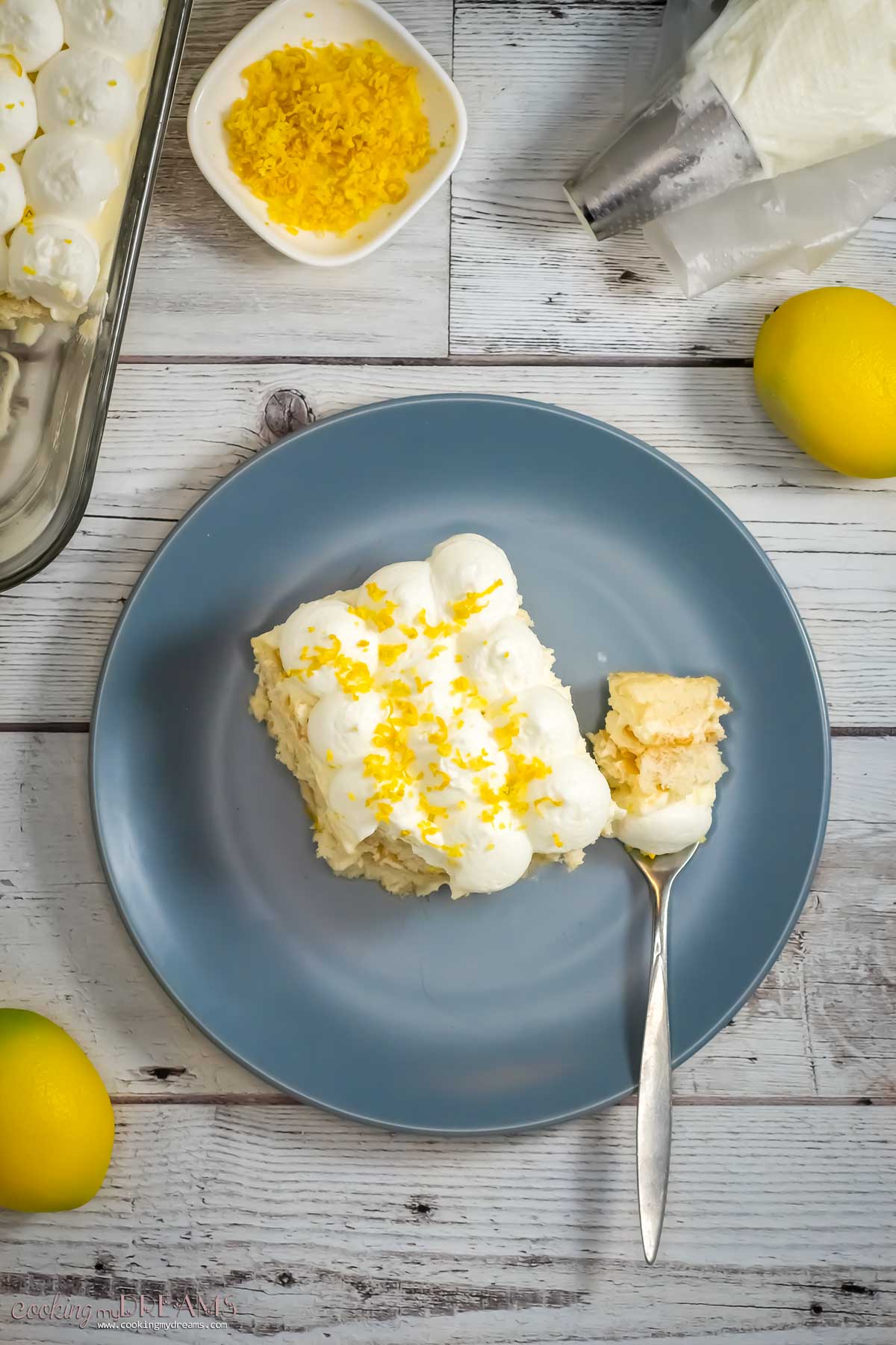 a slice of limoncello tiramisu in a plate with a fork.