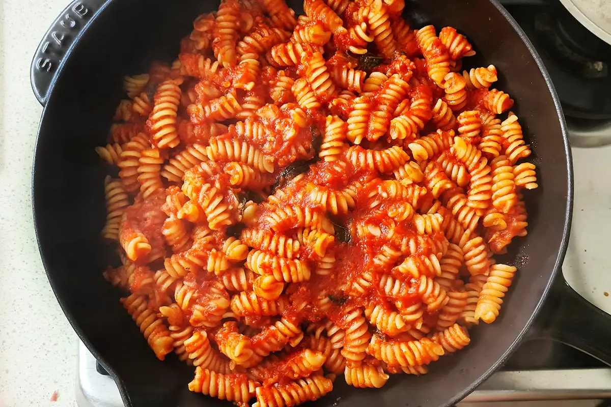 pasta with tomato sauce in a skillet.