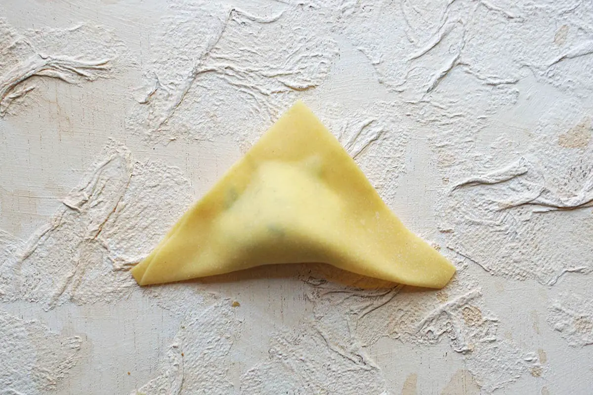 pasta square folded in half to make a tortelloni.