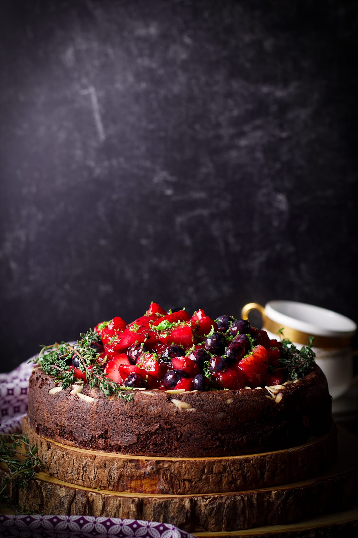 chocolate ricotta cake on a wooden stand.