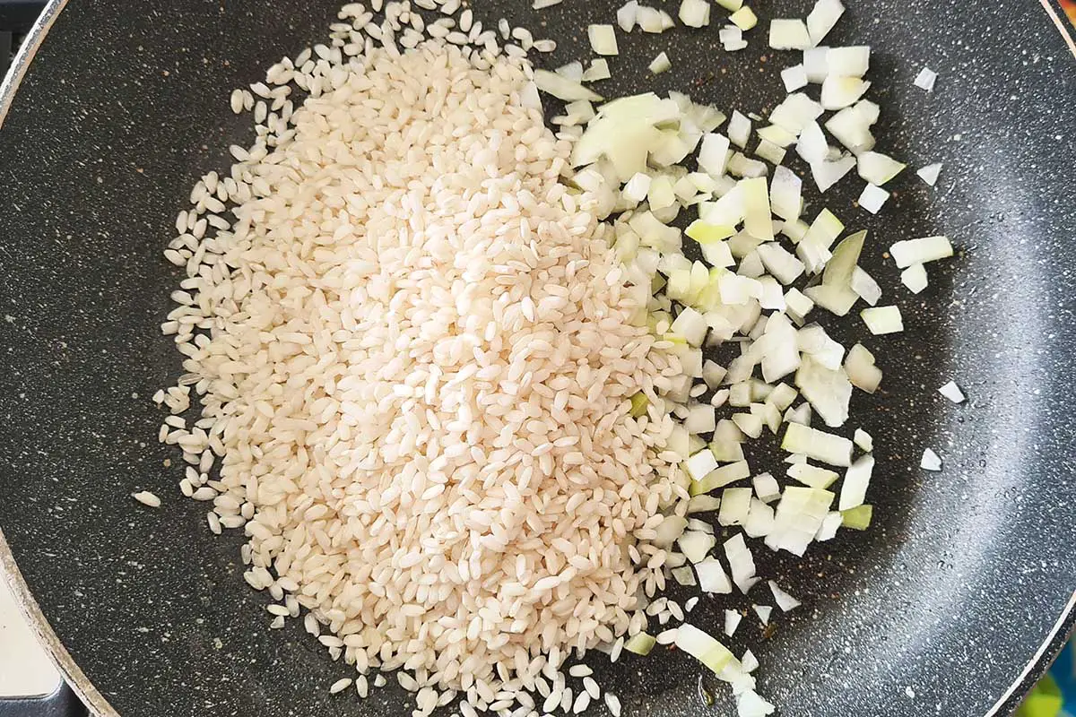 rice an onion in a pan.