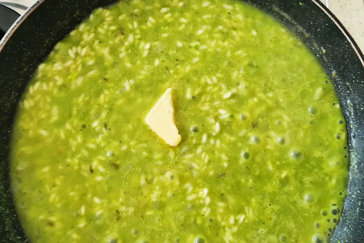 butter is added to the asparagus risotto.
