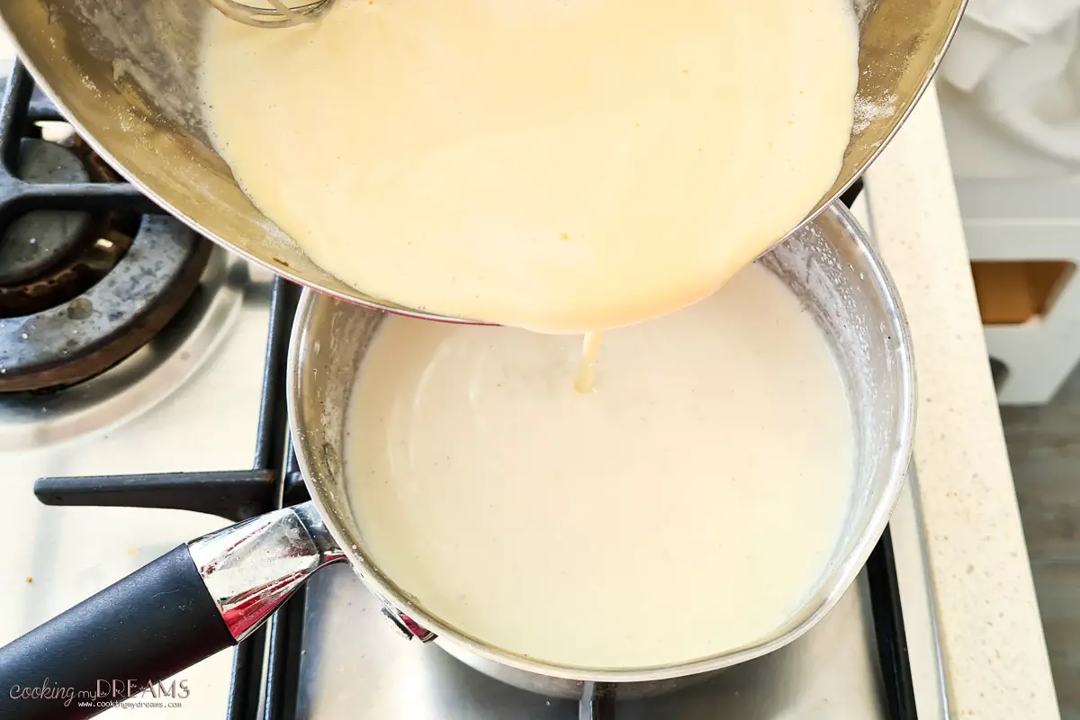 pouring egg mixture into a saucepan of hot milk.