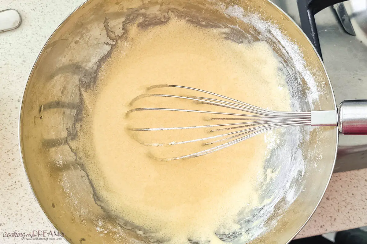 whisk mixing egg mixture in a bowl.