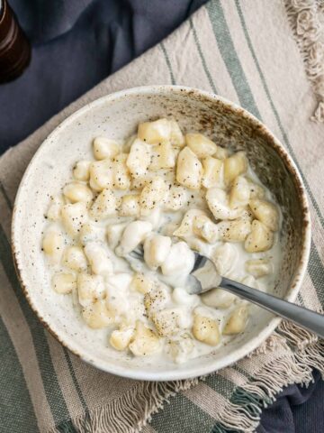 bowl with gnocchetti gorgonzola and a fork.