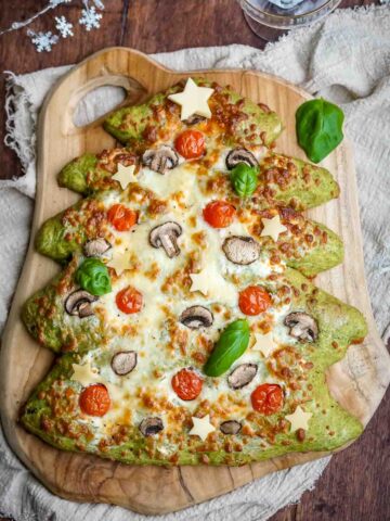 christmas tree pizza on a wooden board.