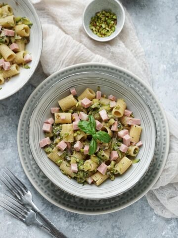 pasta with zucchini pistachio mortadella in a bowl.