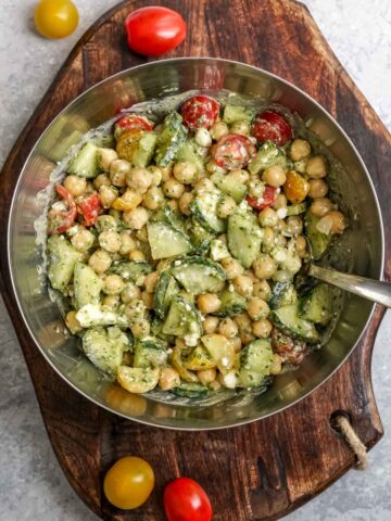 chickpea salad in a silver bowl with a spoon.