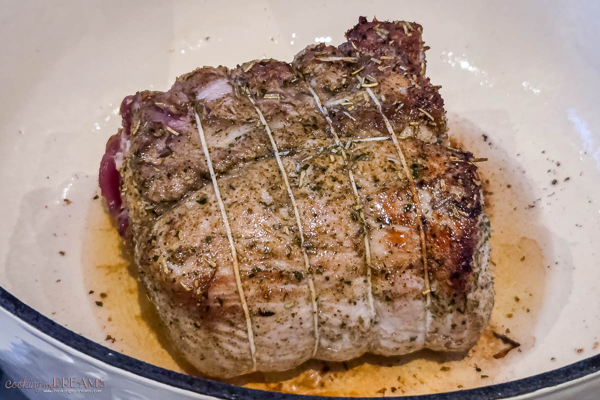 pork loin browning in a dutch oven.