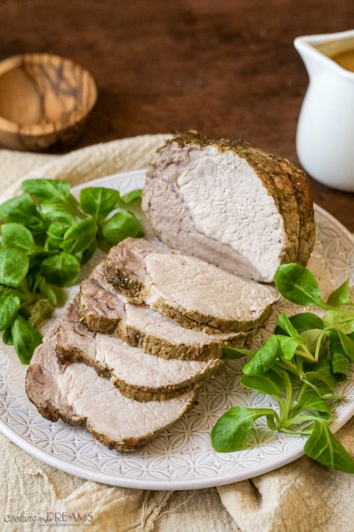 roast pork loin (arista) sliced and served on a platter.