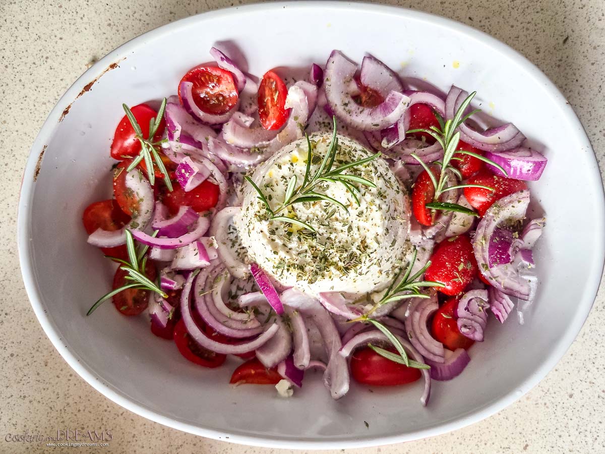 ricotta with onions and tomatoes in a baking dish ready for the oven.