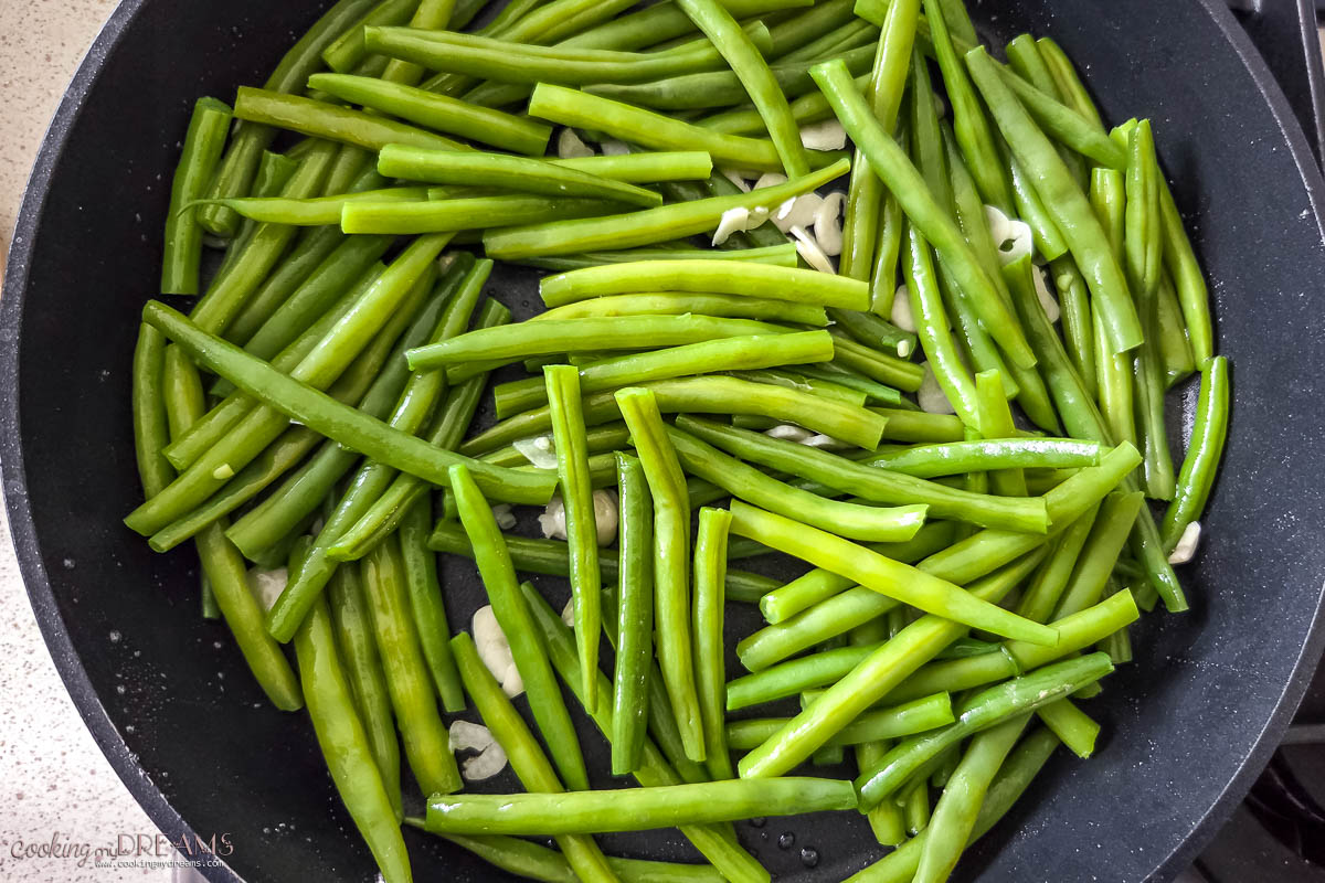 green beans sauteeing in a skillet.
