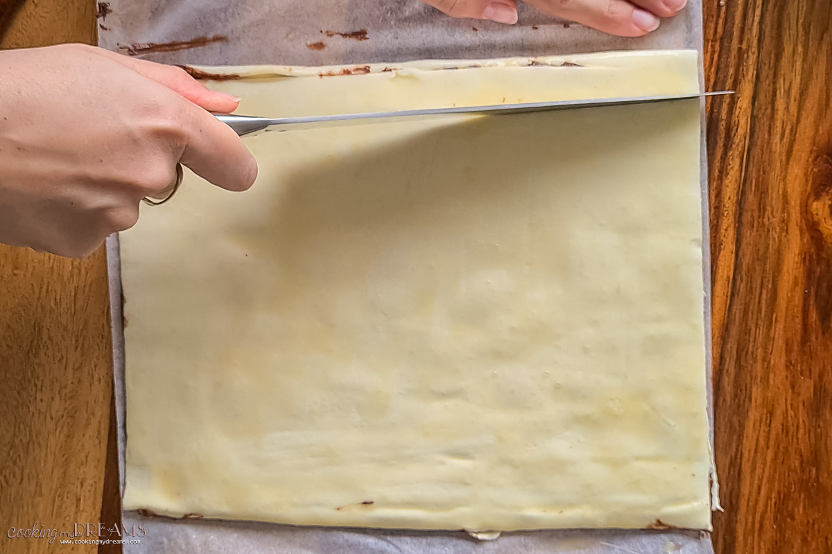 cutting the puff pastry into stripes.