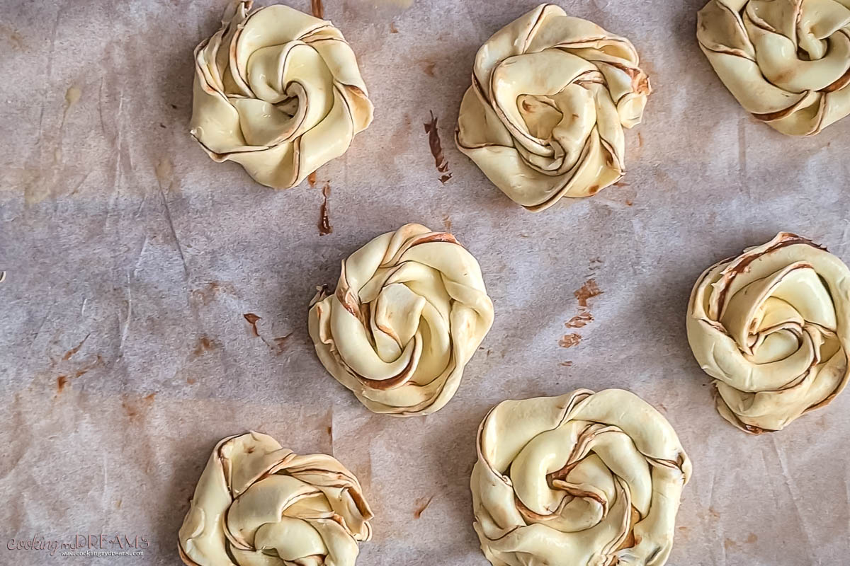raw nutella puff pastries on a baking sheet ready for the oven.