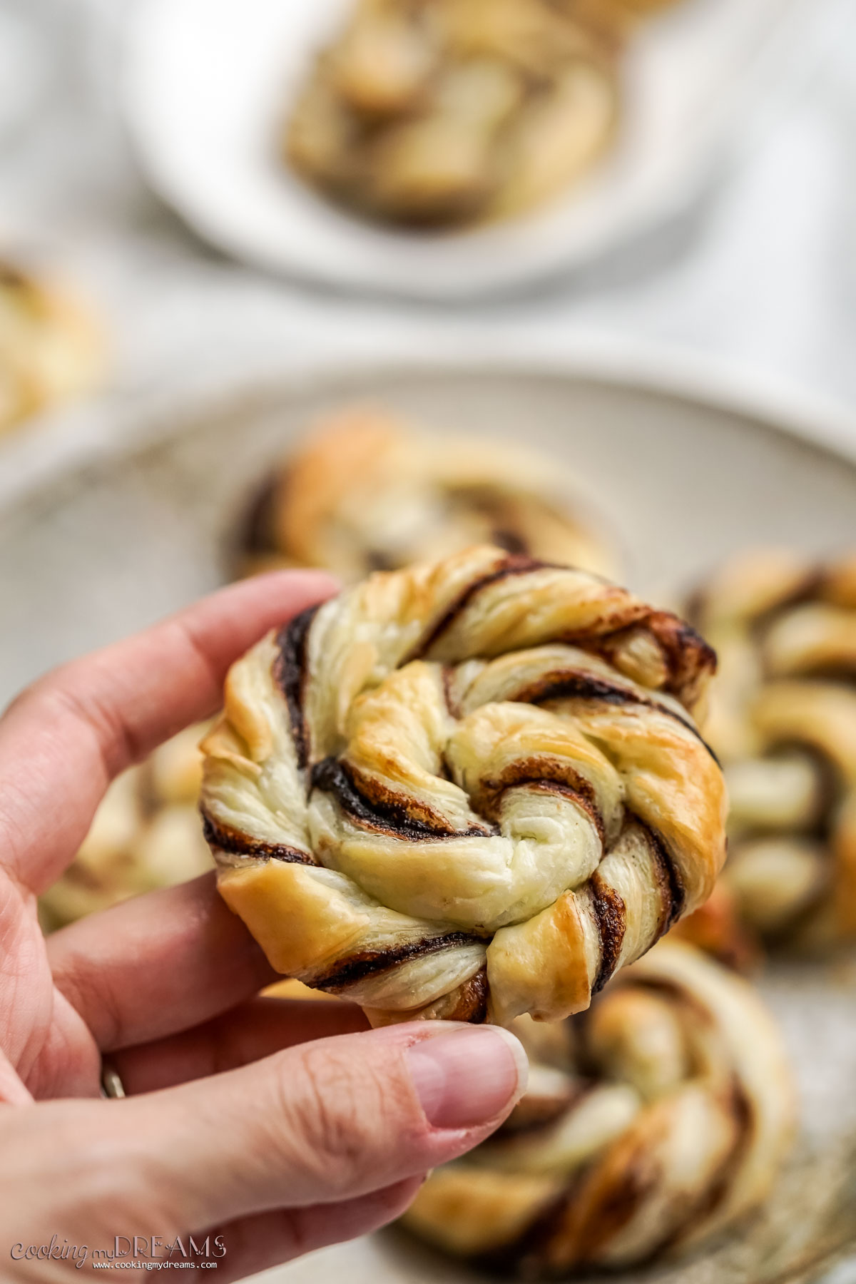 hand holding a nutella puff pastry swirl.