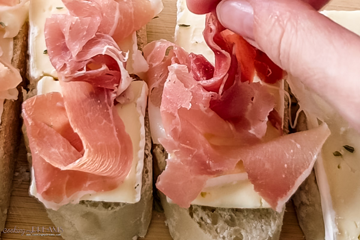 prosciutto slices added on top.