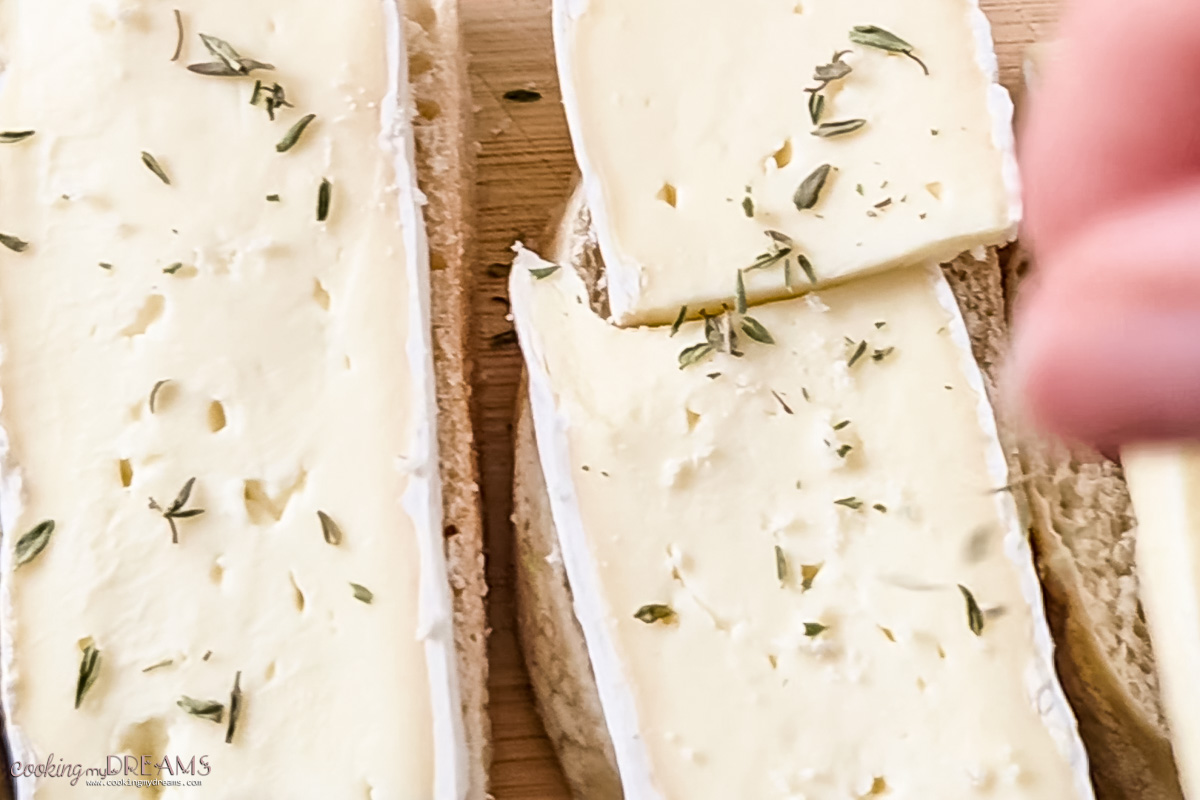 brie on top of crostini, seasoned with thyme.