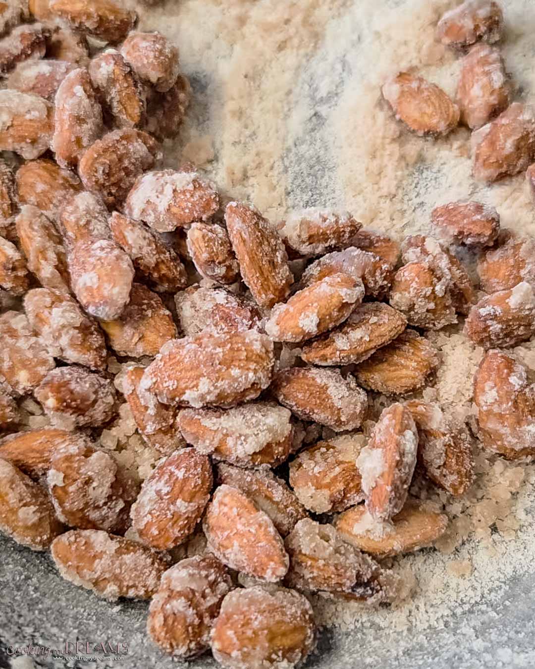 sugar is crystallizing around the almonds in the pan.