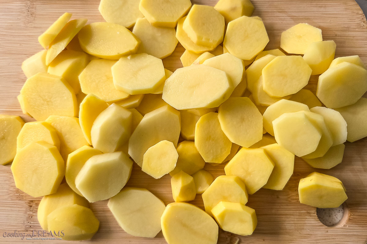 sliced potatoes on a cutting board.