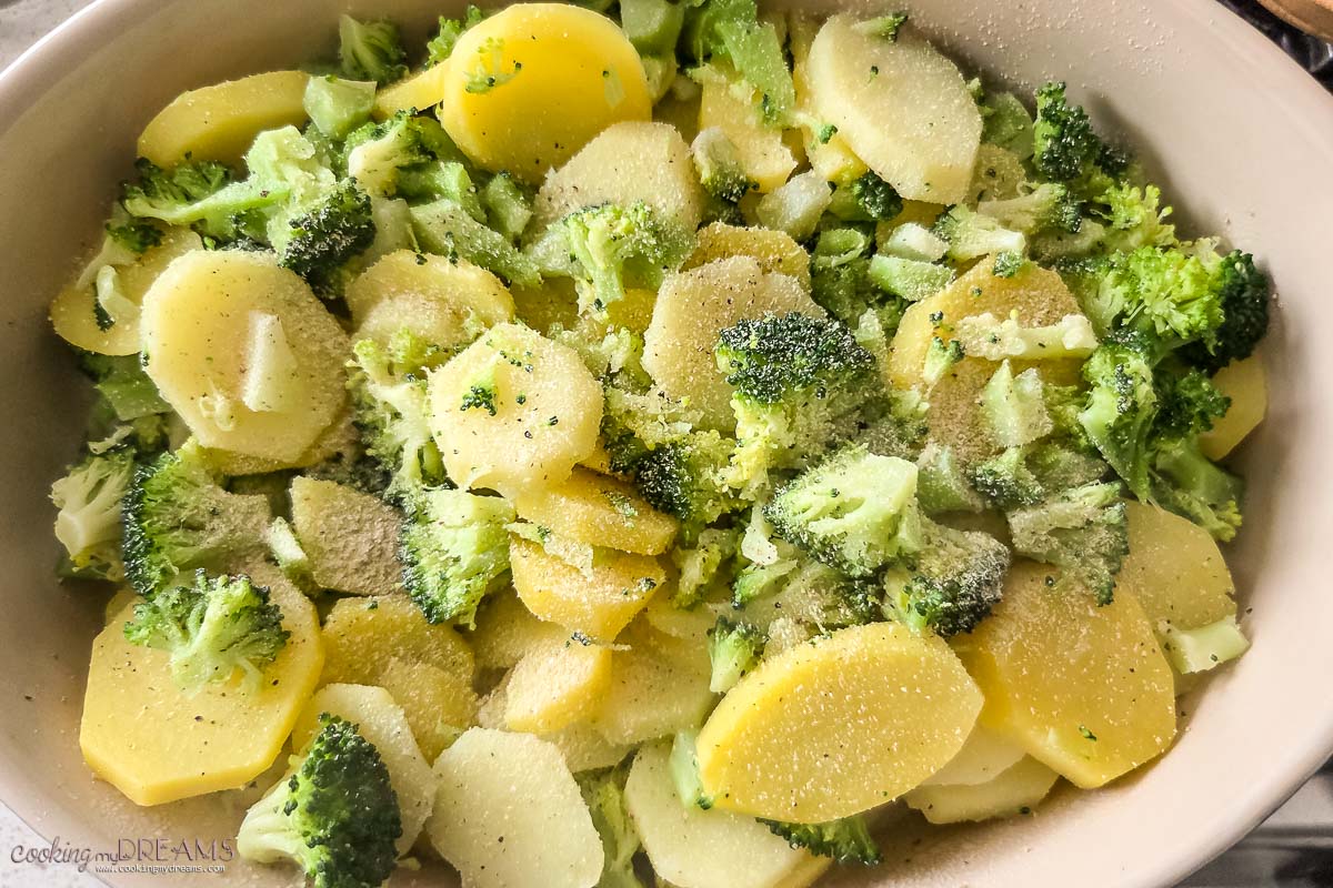 cooked potatoes and broccoli in a casserole dish.
