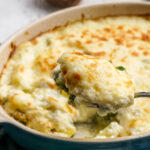 spoon taking a portion of potato broccoli bake.