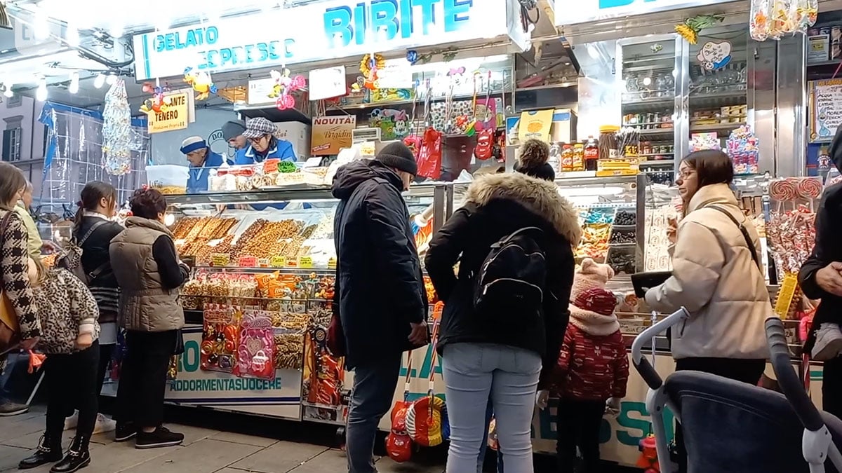 Italian Market stall selling candies and candied nuts.