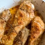 crispy baked chicken drumsticks in a baking dish.