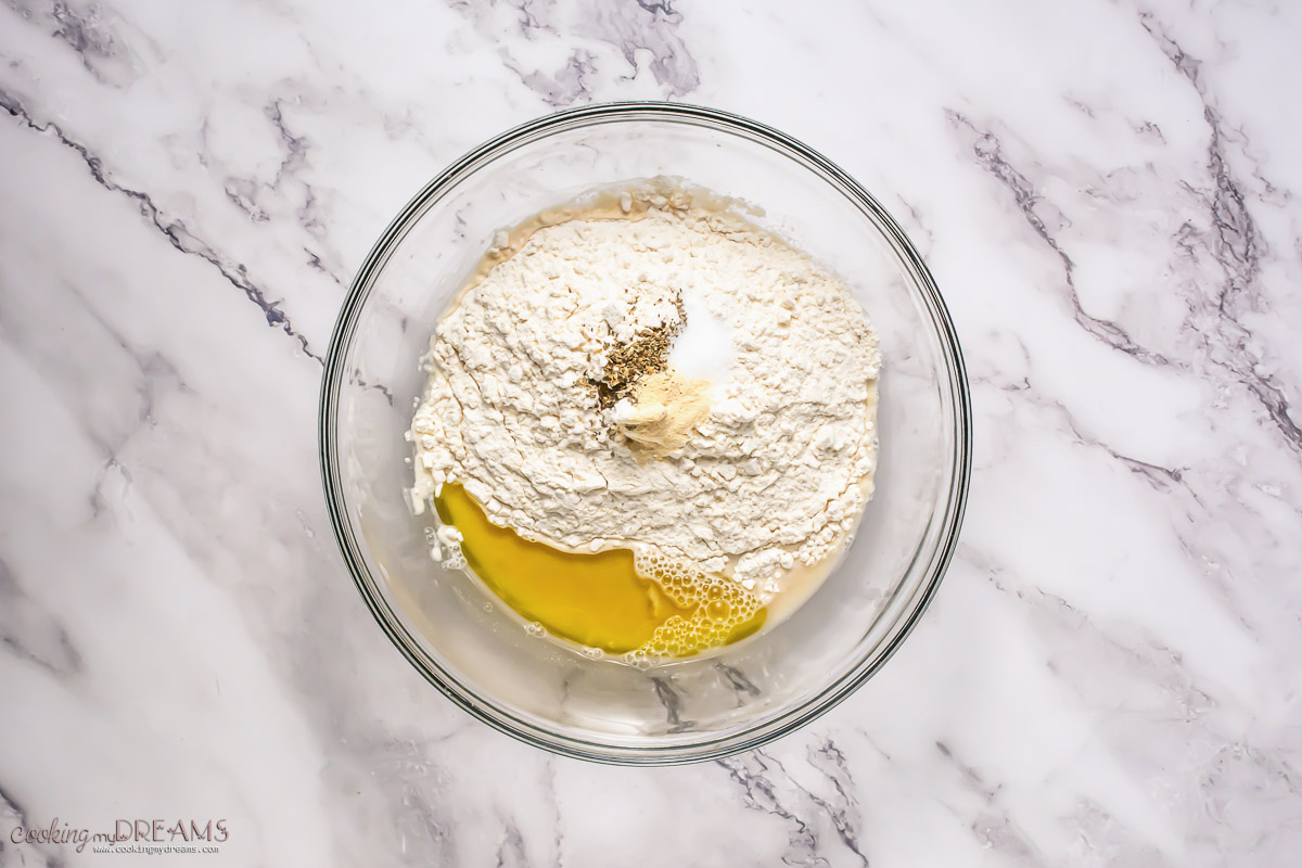 all the pizza dough ingredients in a bowl.