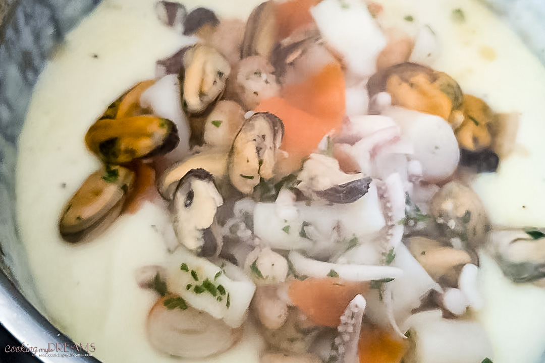 cooked seafood is added to the bechamel sauce.