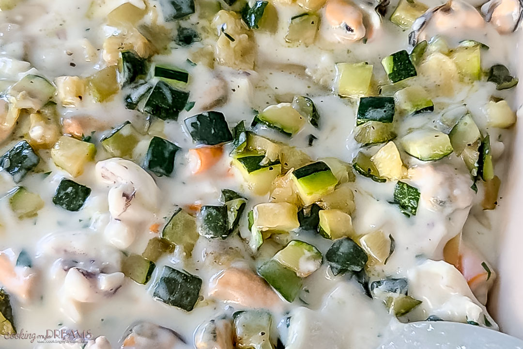 layer of seafood bechamel sauce and sautèed zucchini.