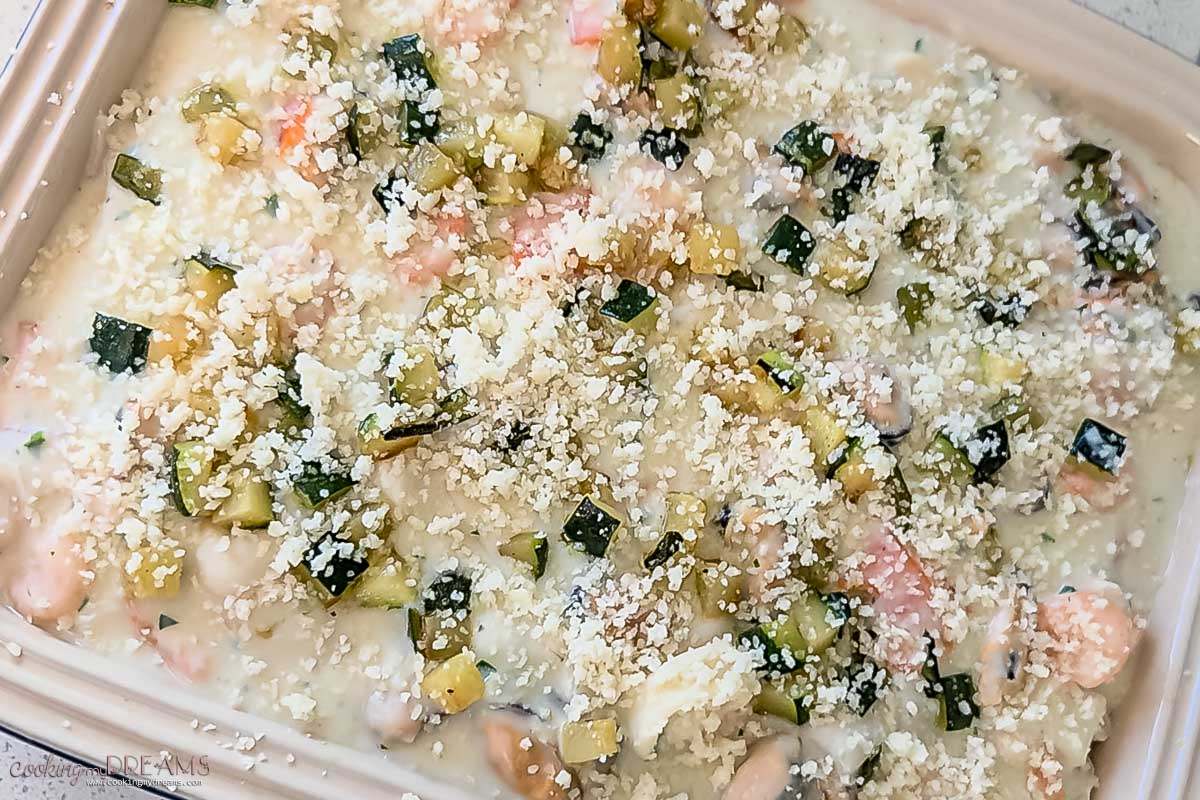 lasagna is topped with parmesan cheese and ready for the oven.