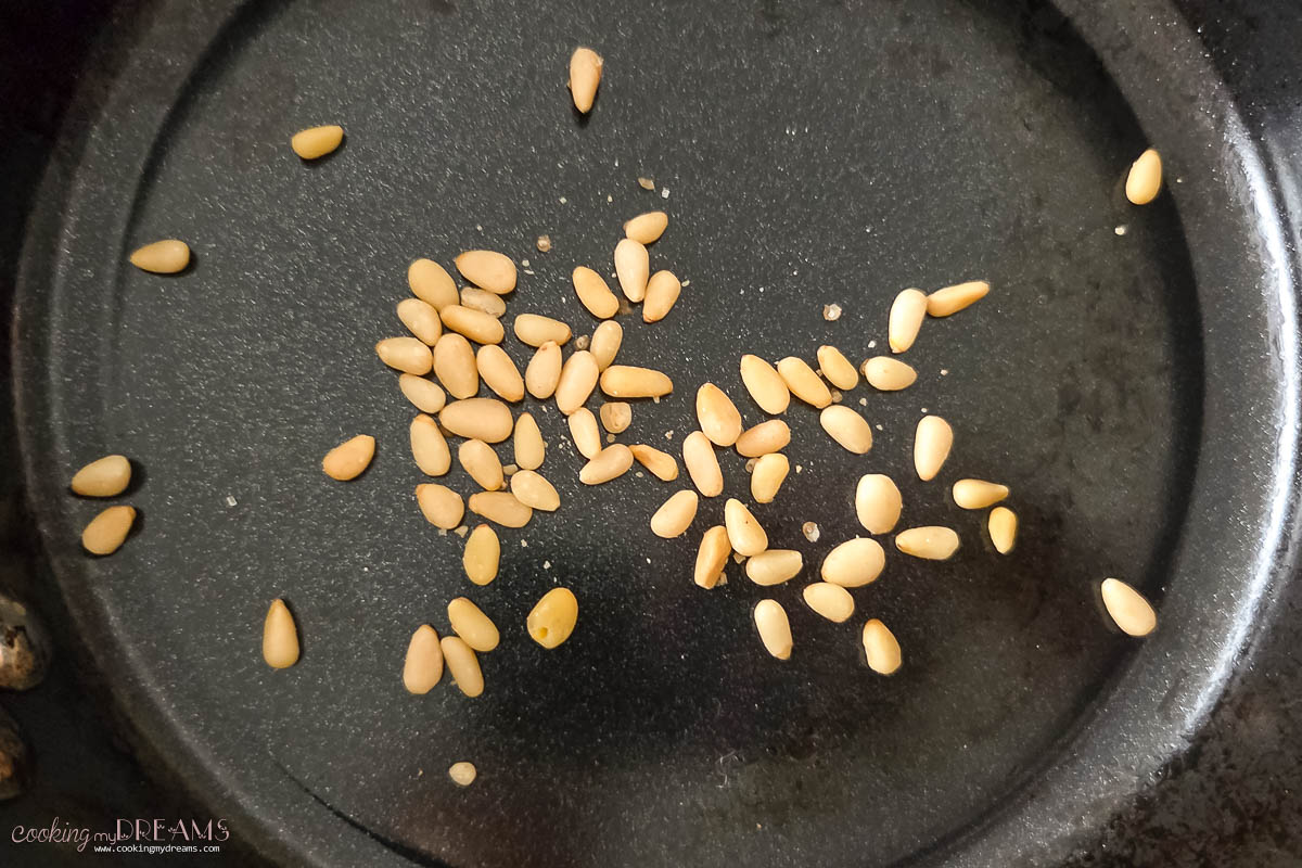 pine nuts toasting in a skillet.