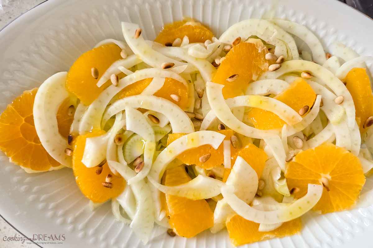 season the salad in the serving dish and add pine nuts.