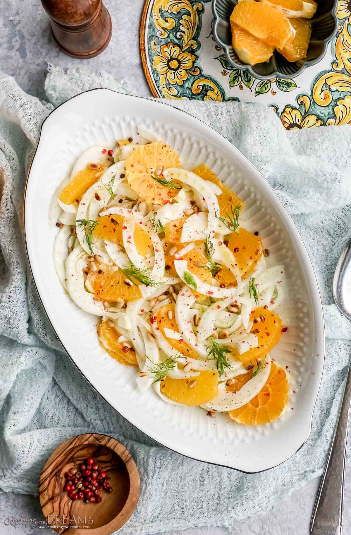 italian orange fennel salad on a serving dish topped with pine nuts.