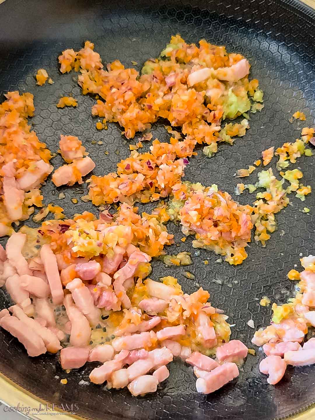 soffritto and pancetta cooking in a skillet.