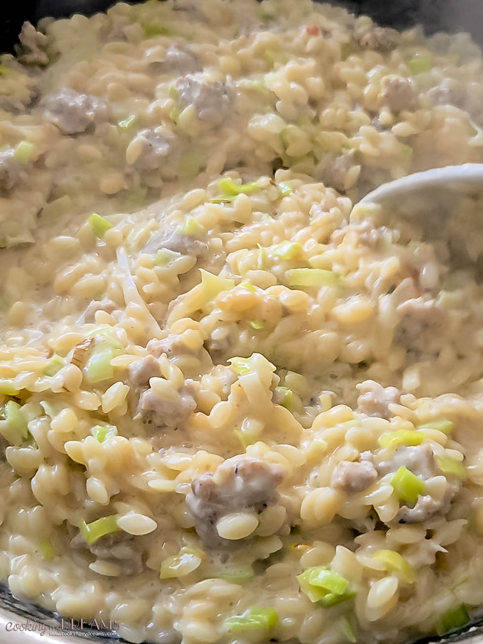 creamy sausage and leek orzo simmering in the skillet.