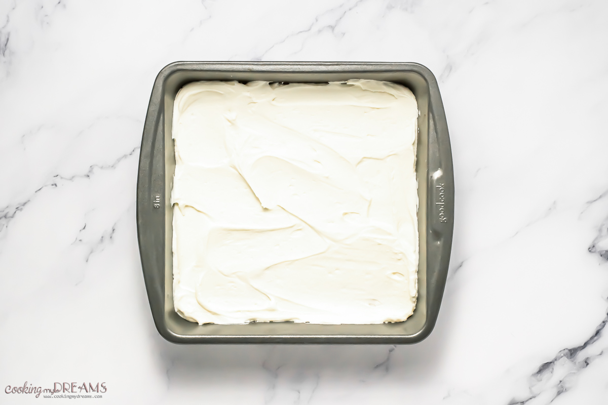 layer of mascarpone cream on top on the ladyfingers.