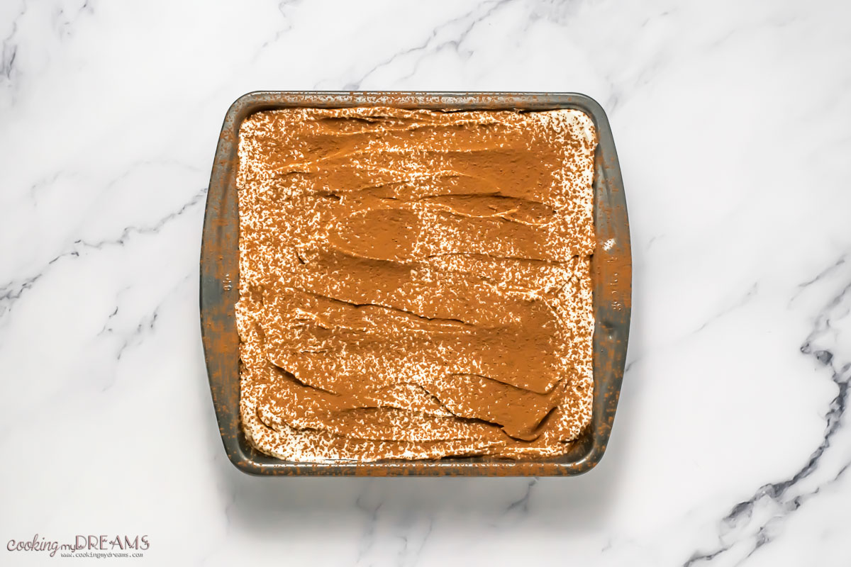 final dusting of cocoa on top of the tiramisu.