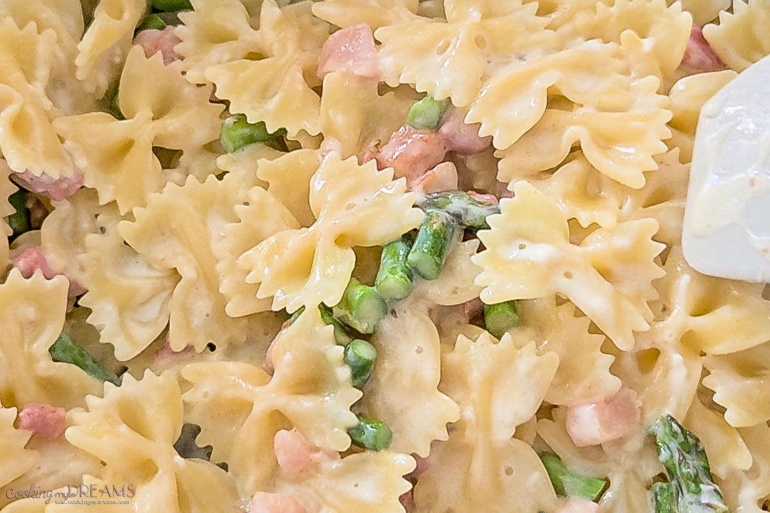 cream is added to the pan with the pasta.
