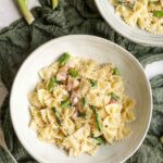 two bowls of creamy pasta with aspragus and pancetta.