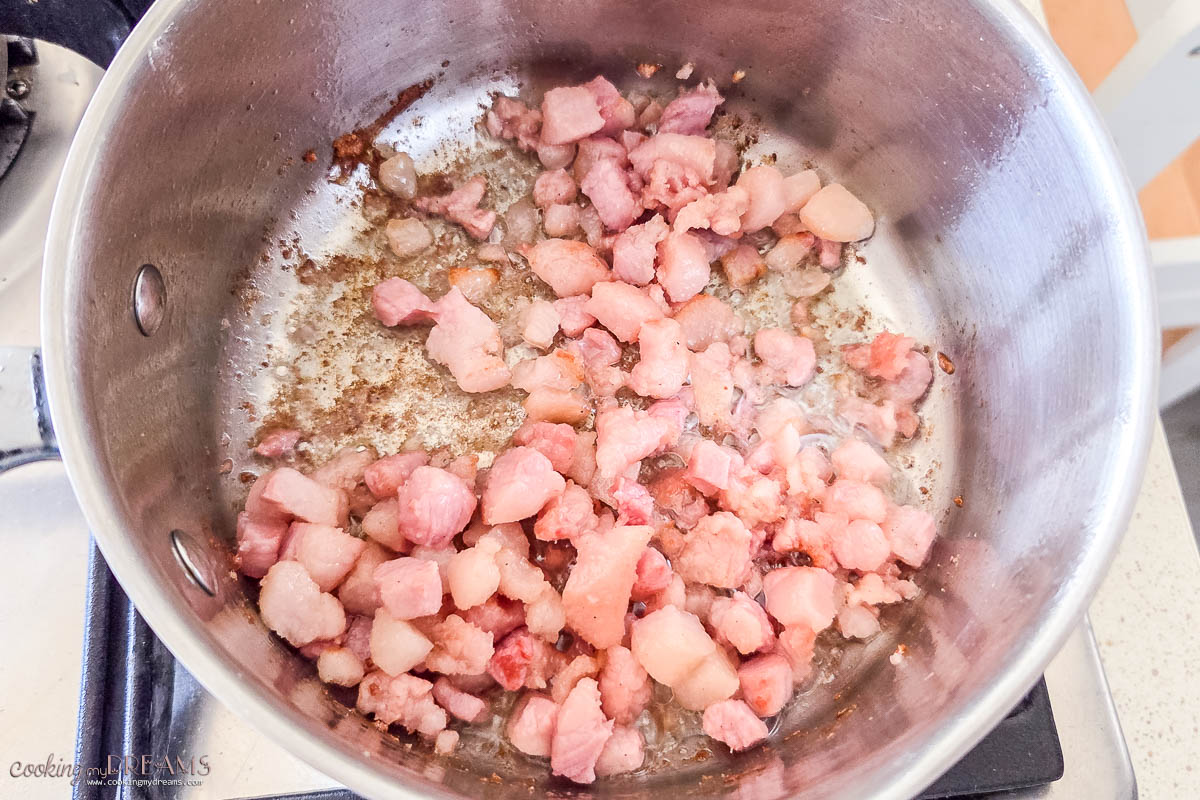 guanciale browning in a pot.